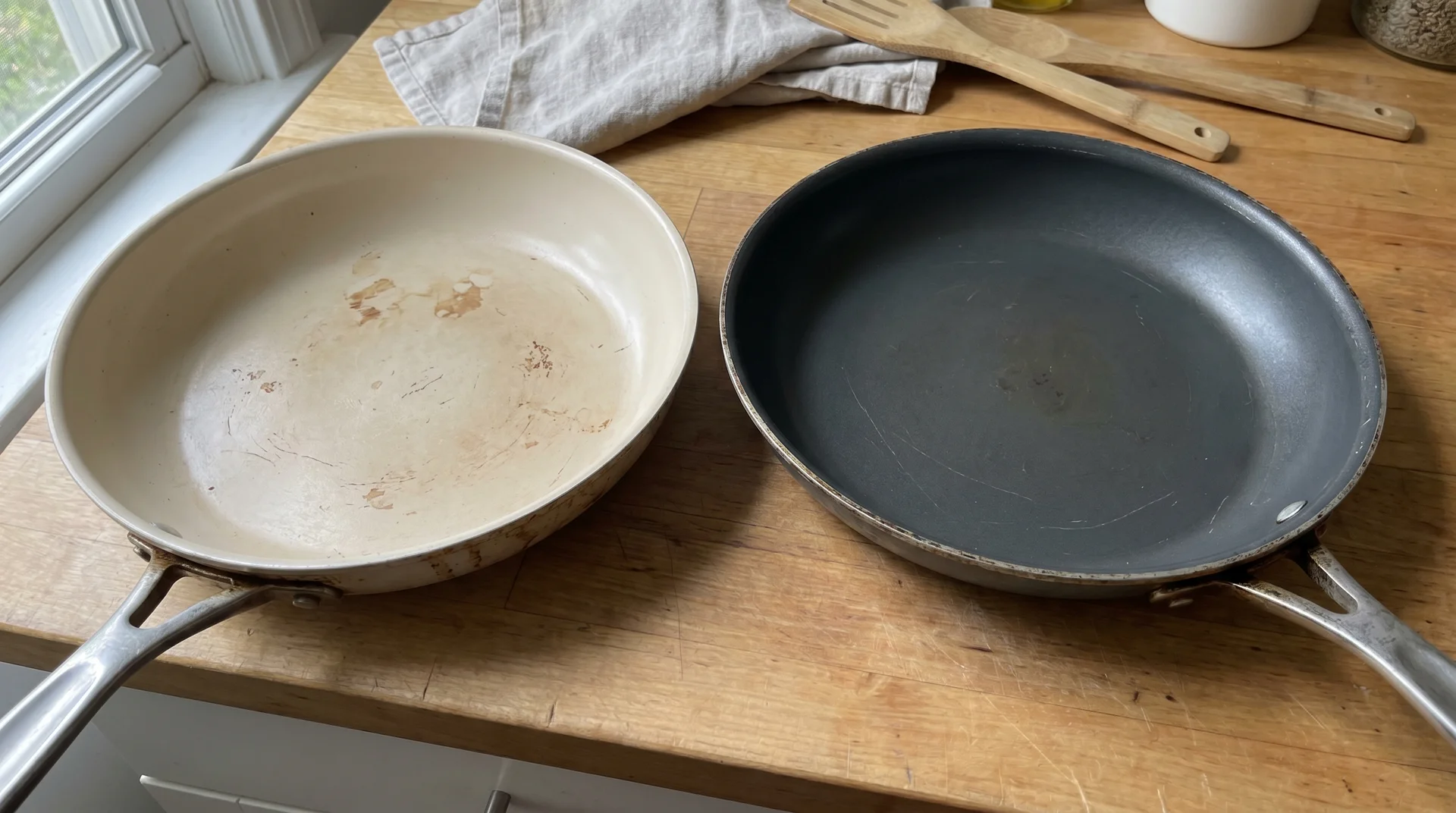 Ceramic-coated skillet and PTFE nonstick skillet side by side, neutral comparison

