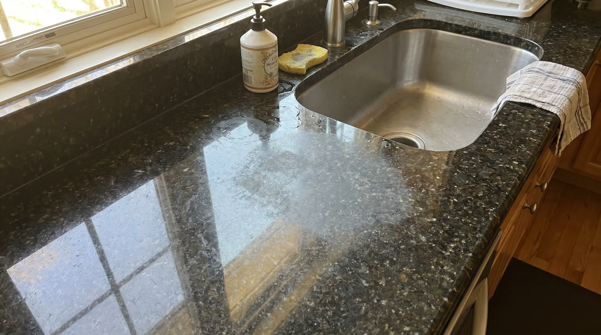 Dull granite countertop area near a frequently used sink