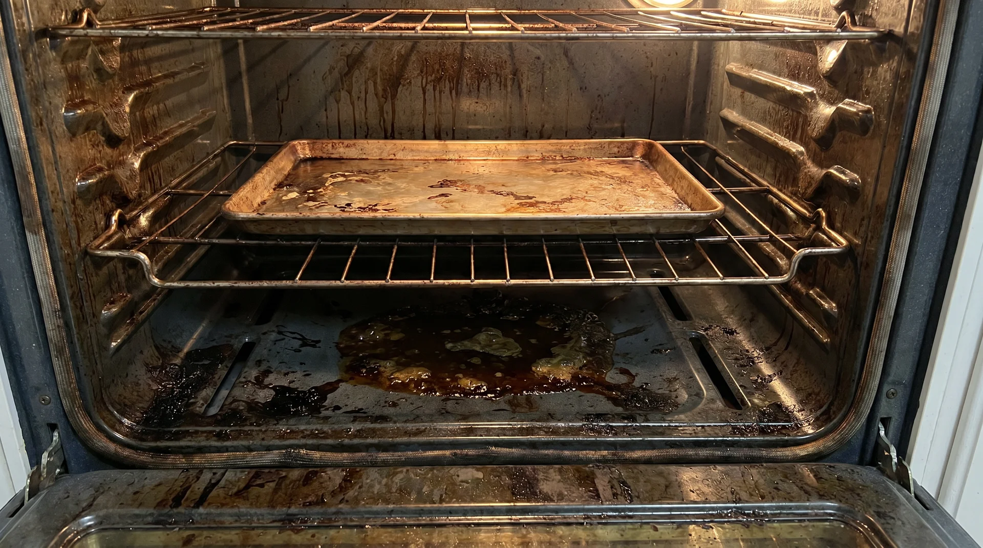 Oven interior with heavy grease buildup before self-cleaning