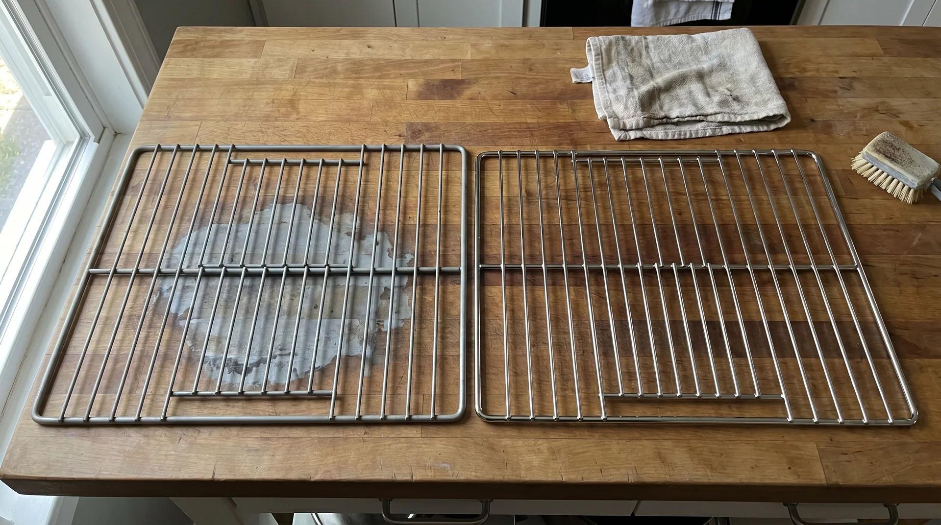 Oven rack with chrome discoloration from self-clean cycle heat next to undamaged rack