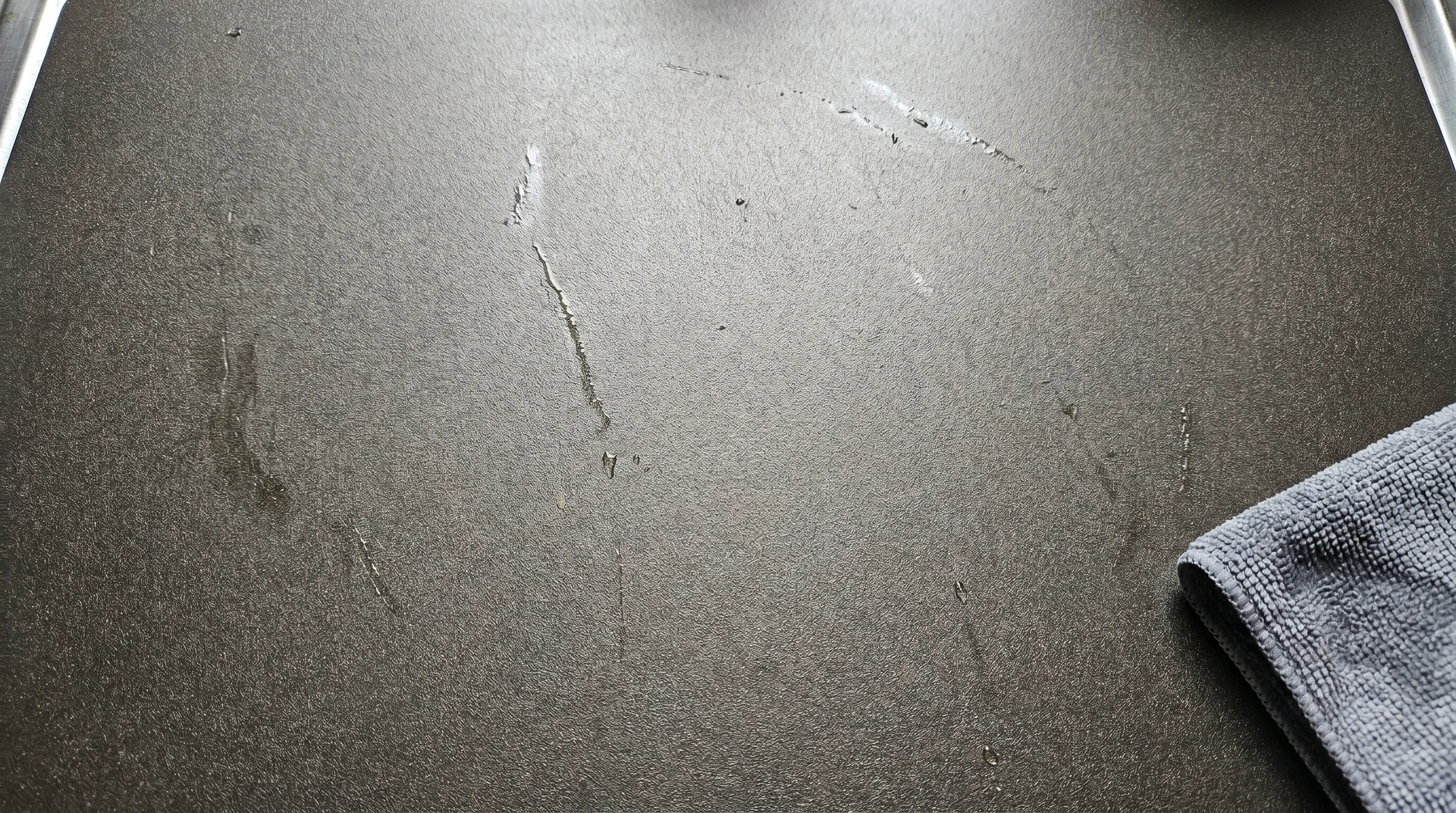Titanium cutting board surface after raw chicken prep showing no staining or liquid absorption
