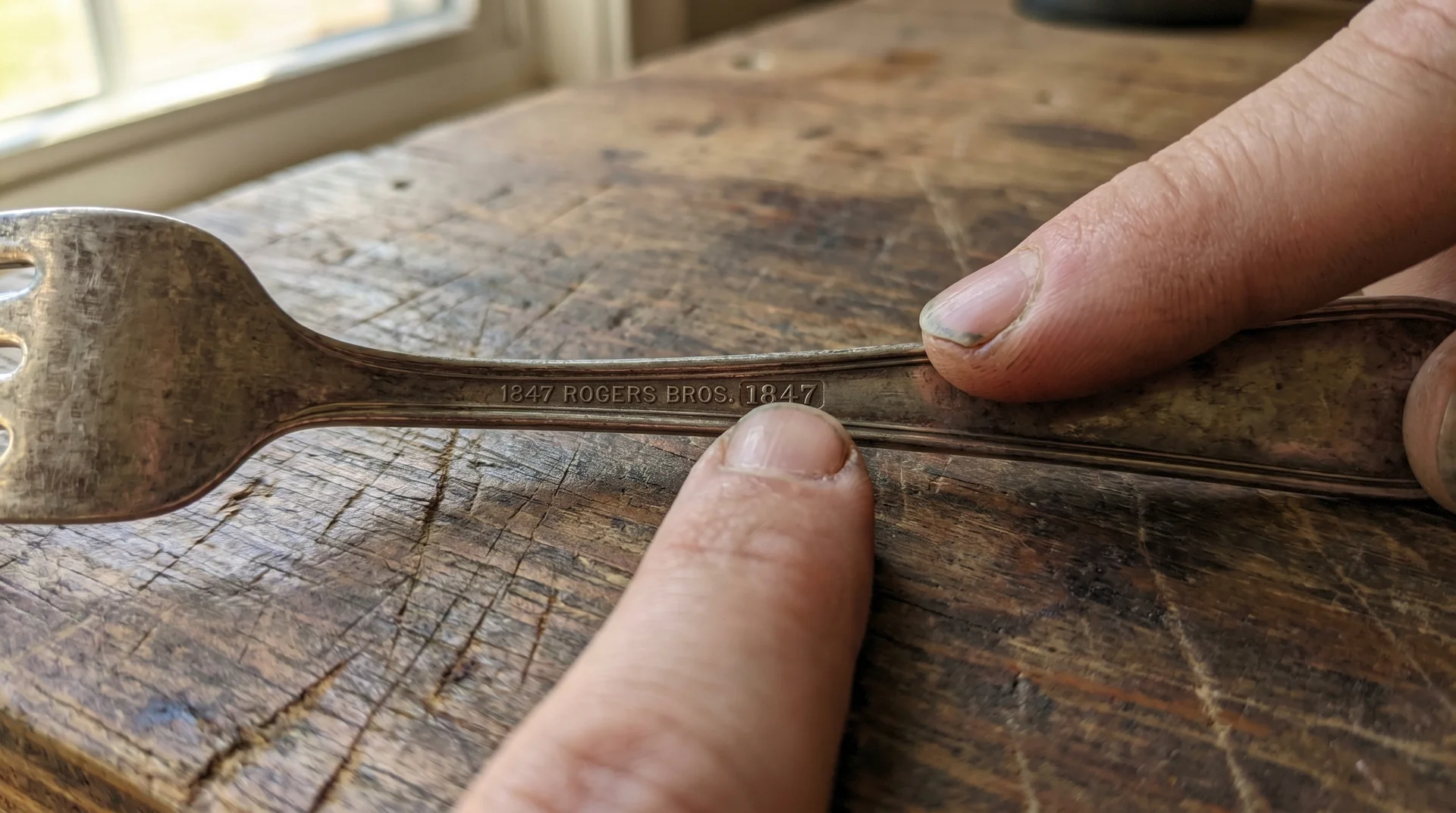 Back of 1847 Rogers Bros flatware handle with stamp in focus showing brand name not manufacturing date
