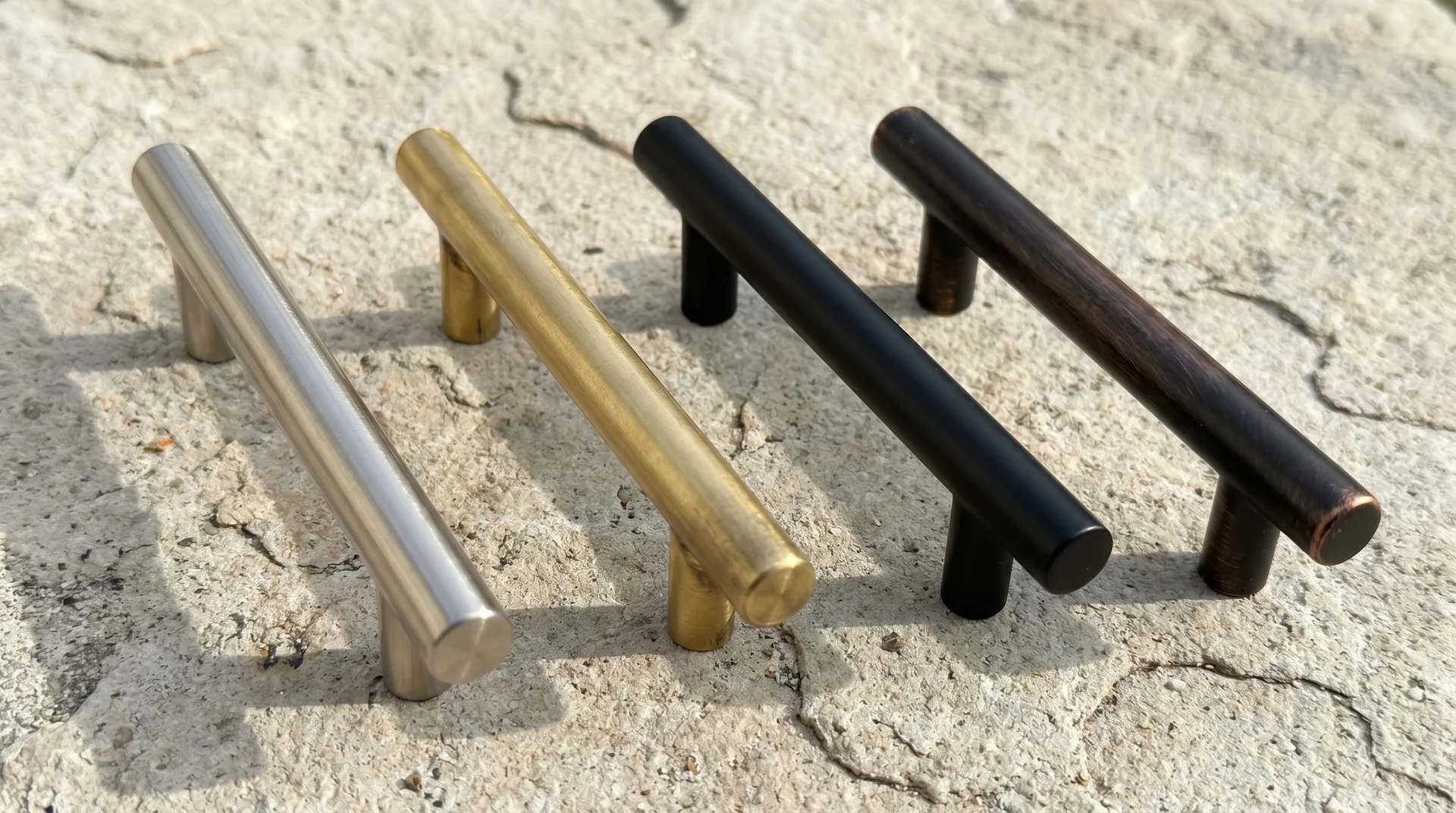 Four cabinet hardware finishes compared — brushed nickel, satin brass, matte black, and oil-rubbed bronze