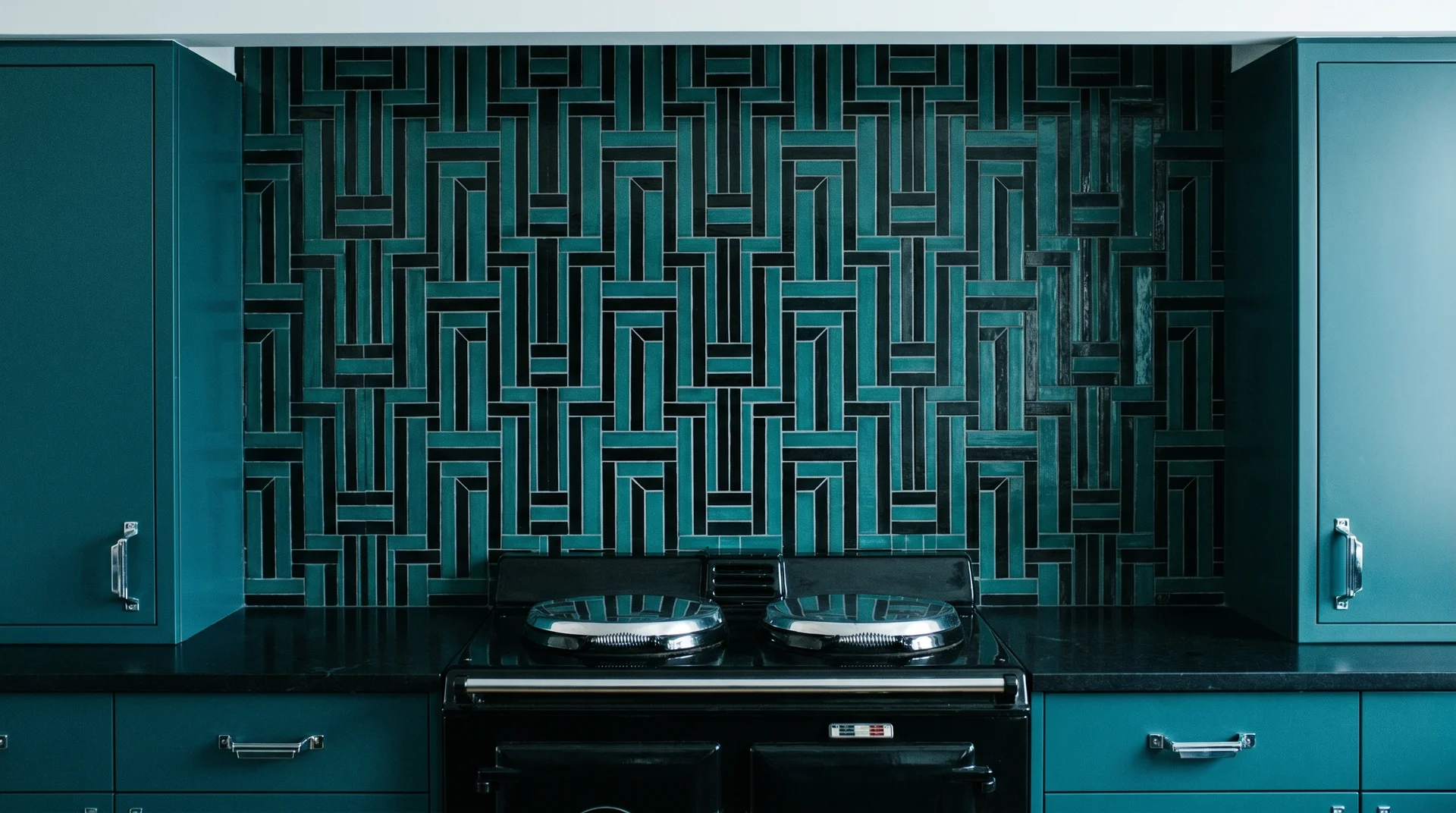 Geometric teal and black mosaic backsplash tile with chrome hardware in an Art Deco kitchen