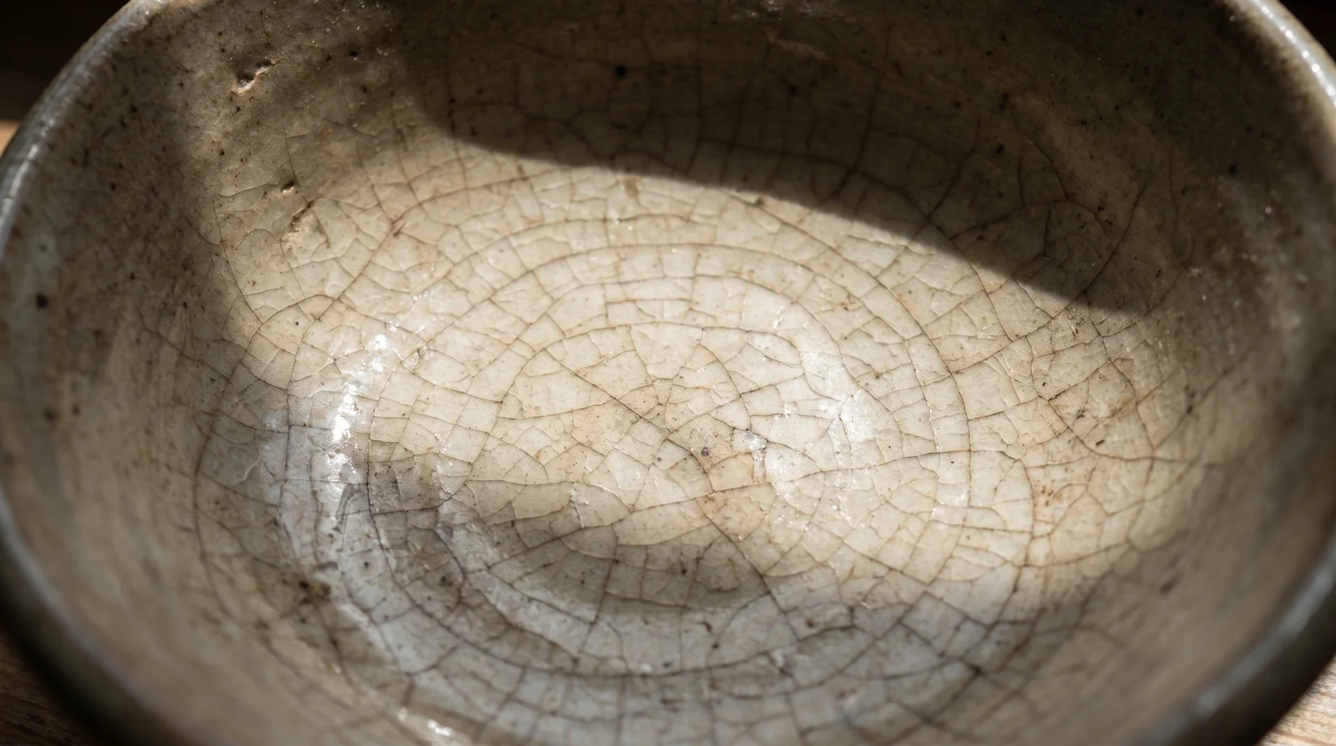 Glaze crazing on stoneware bowl interior showing hairline surface cracks from wear