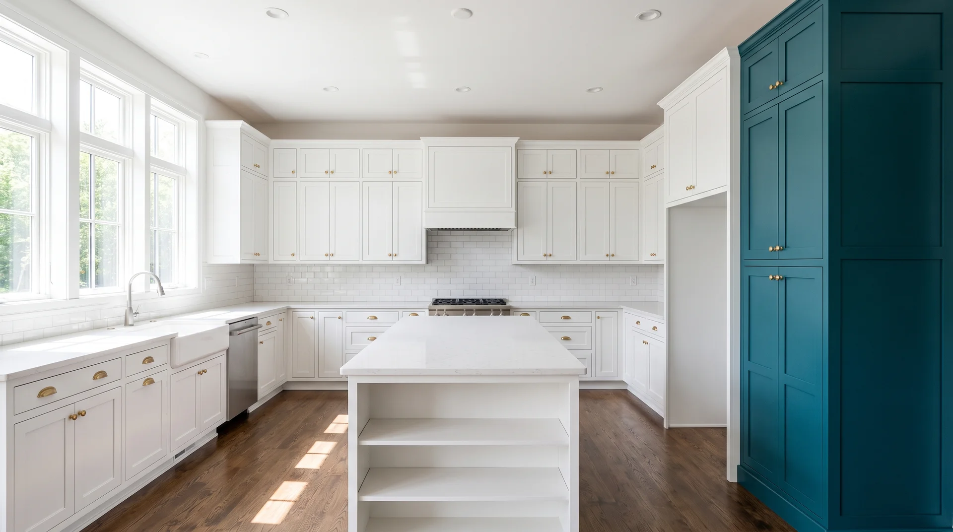 Single deep teal floor-to-ceiling pantry cabinet column at the end of a white Shaker kitchen cabinet run