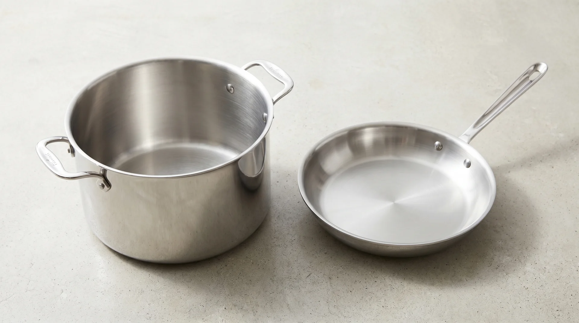 Stockpot and frying pan side by side showing the difference in depth and side height
