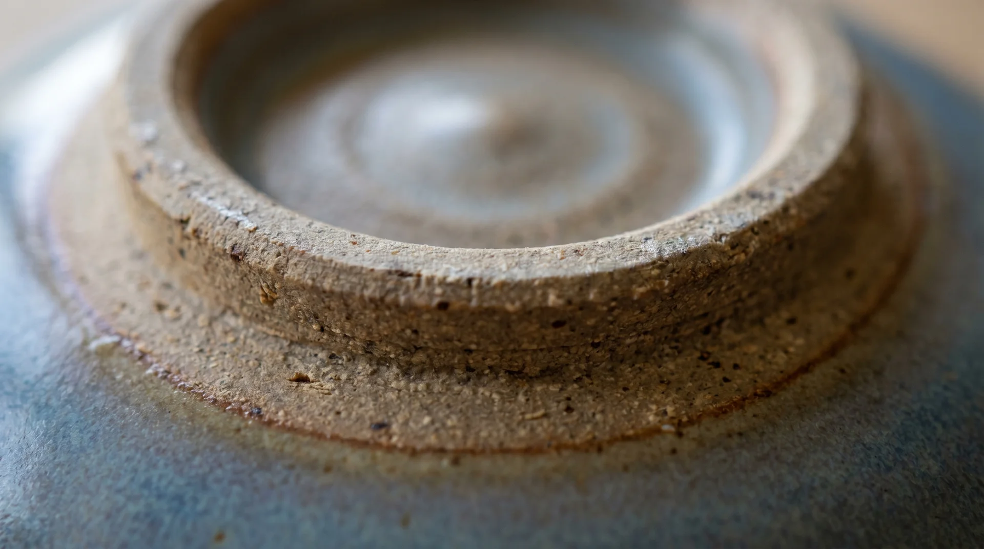 Unglazed stoneware foot ring exposed at base of bowl, showing raw clay texture