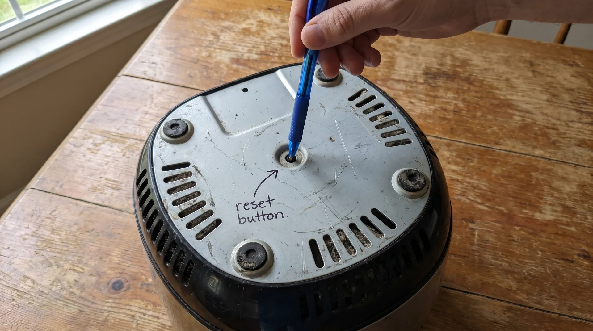 hidden reset button on air fryer base — how to press it to restore power